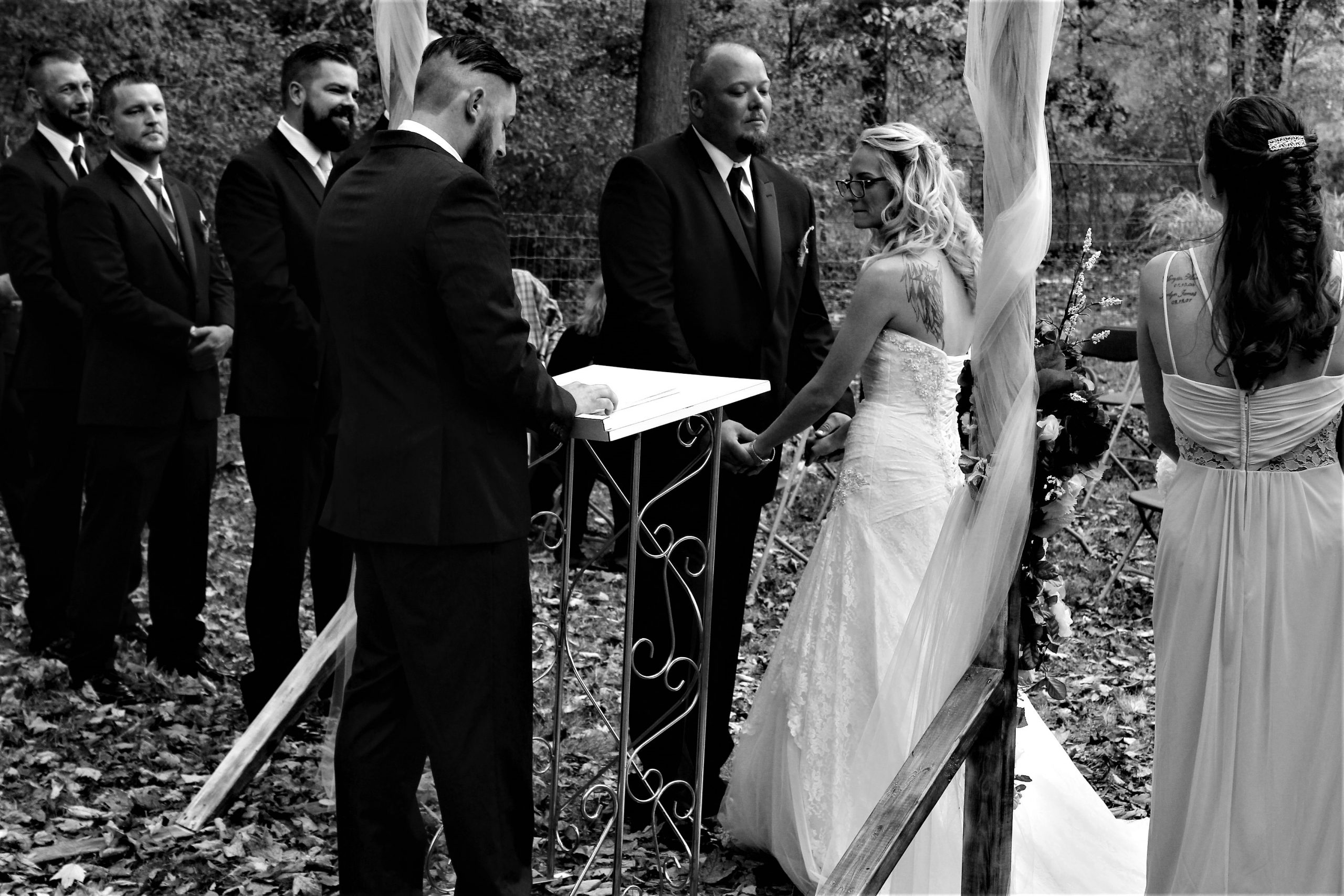 IMG_9494 (2) (1) A couple at the altar of their wedding in black and white